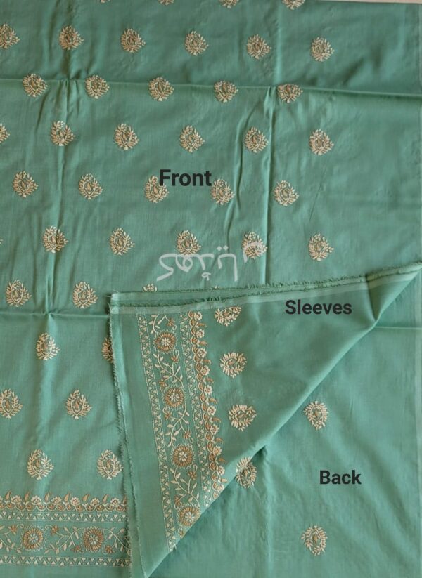 Close-up of pale ivory hand embroidery on shirt front