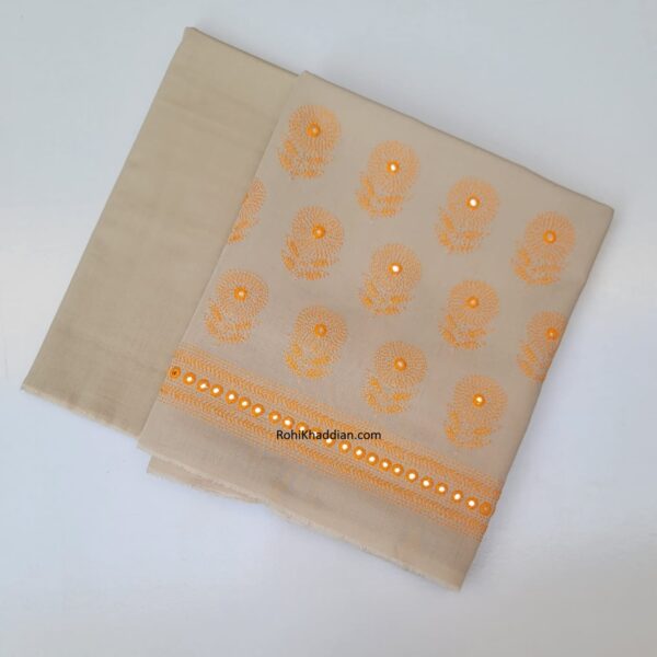 Almond beige pure cotton khaddar suit with golden orange hand embroidery and decorative border by Rohi Ki Khaddian Pakistan.