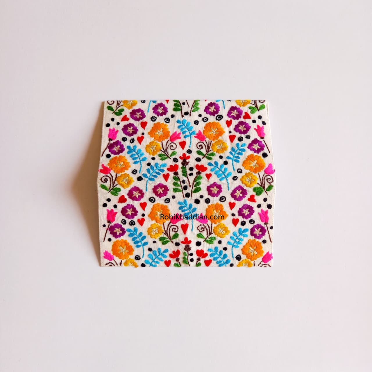 Close up of Midsummer Garden wallet featuring Orange, Purple, Magenta and Sky Blue floral embroidery