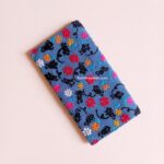 Night Florals embroidered wallet for women featuring colorful flowers and black botanical embroidery on a blue background